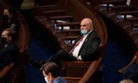 Mike Kelly, wearing a Covid mask, sitting on his own in Congress.
