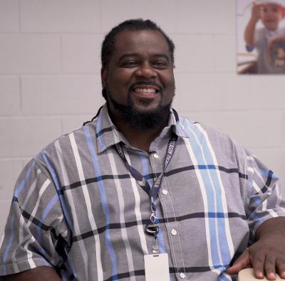 Milton Thomas sitting at a table